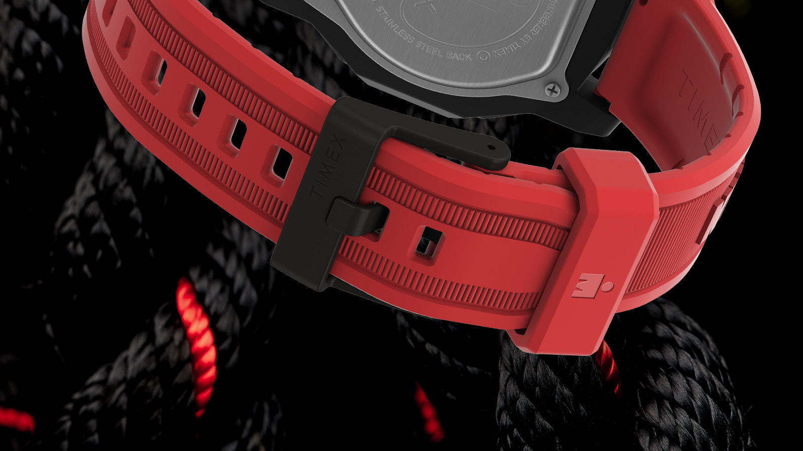 Close-up of the red silicone strap on the TIMEX® IRONMAN® Adrenaline Ana-Digi watch with black buckle engraved with “Timex.”