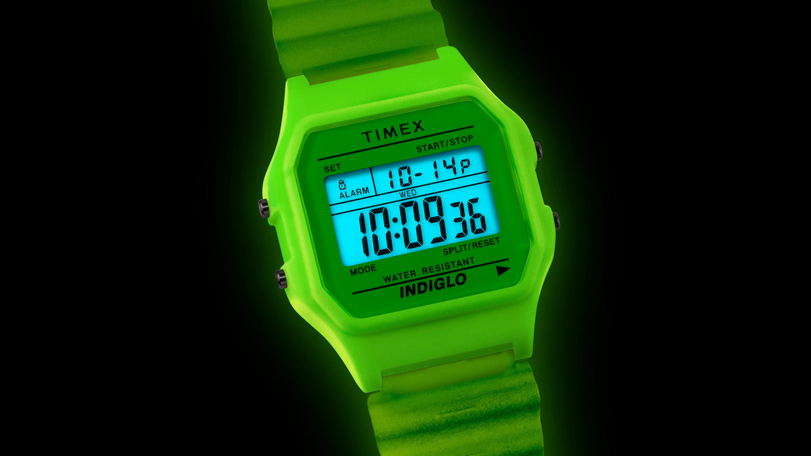 Close-up of the TIMEX® T80 digital display glowing under INDIGLO® light, showing time, alarm, and stopwatch details.