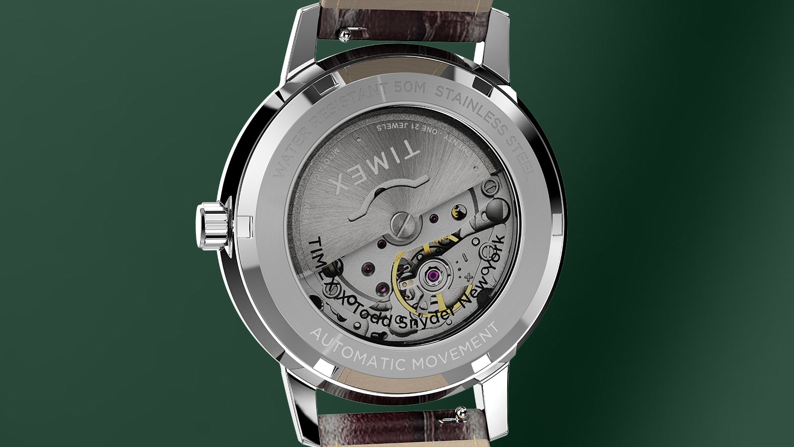 Close-up of the Todd Snyder x Timex Olive Marlin Automatic caseback, showing the 21-jewel automatic movement through the exhibition window.