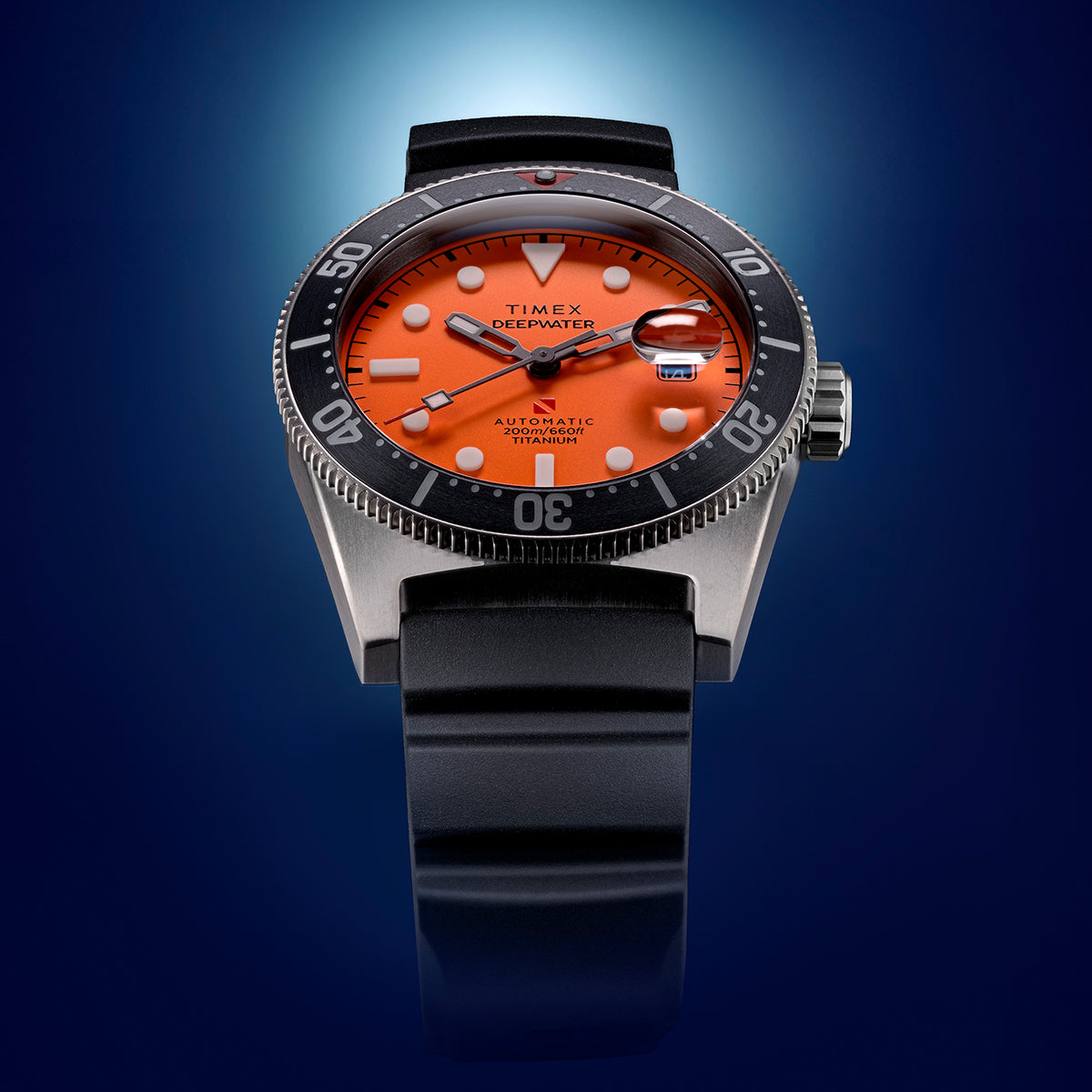 Close-up view of the Timex Deepwater Reef 200 showing its vivid orange dial, bold white markers, black bezel, and black rubber strap.