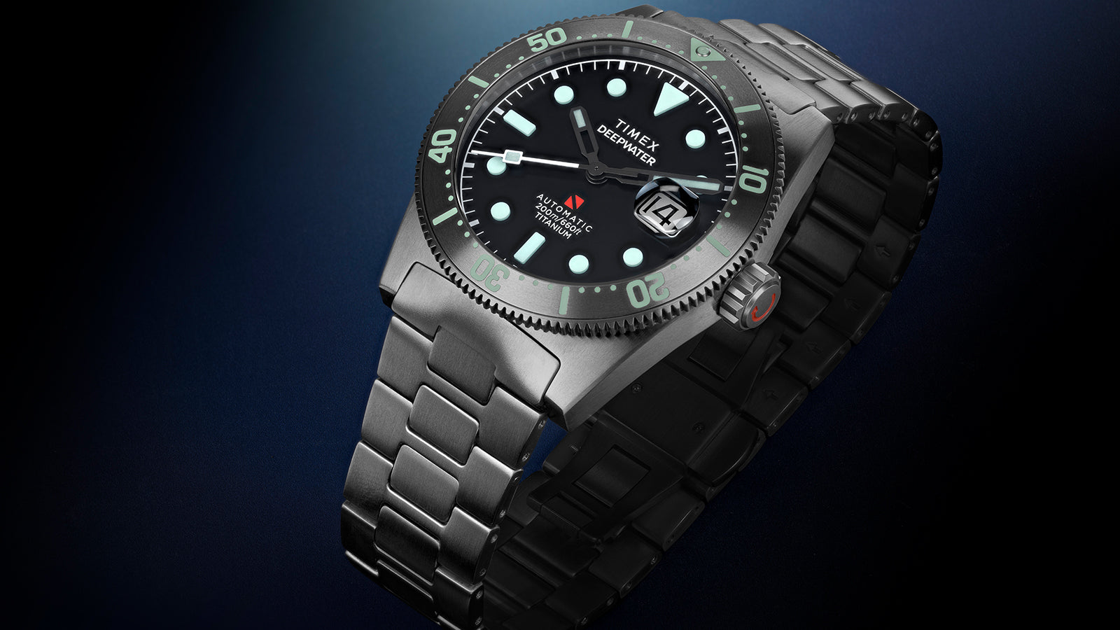 Timex Deepwater Reef 200 Titanium watch displayed at an angle, highlighting the black dial, aqua luminescent markers, titanium bezel, and matching titanium bracelet.