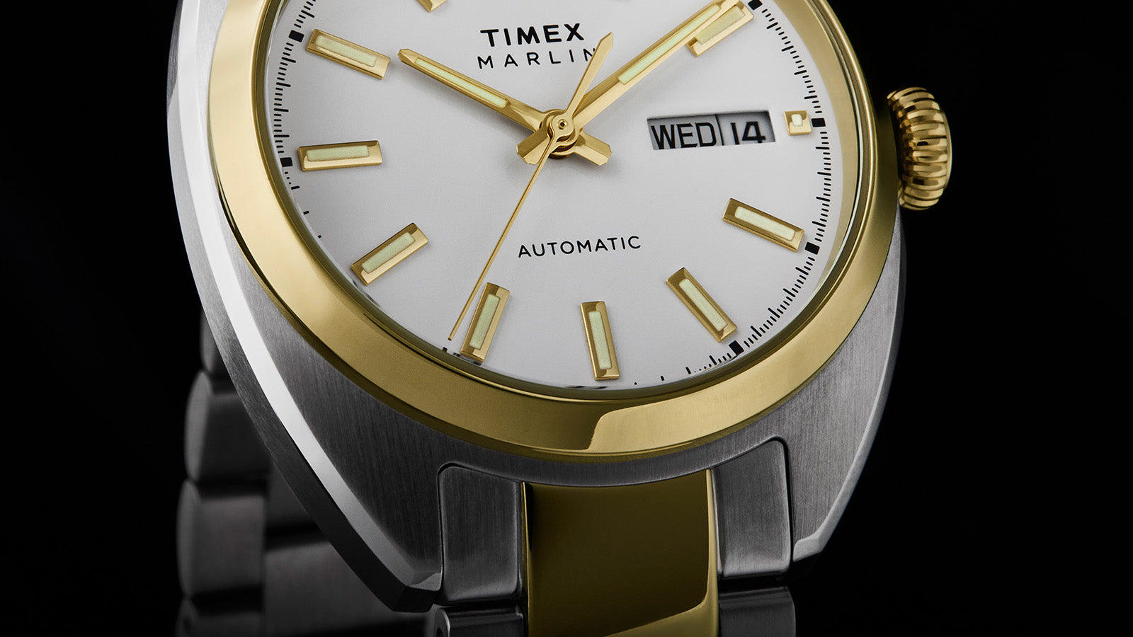 Detail view of the Timex Marlin® Draper Automatic dial showing gold-tone markers, automatic text, and brushed stainless steel case.
