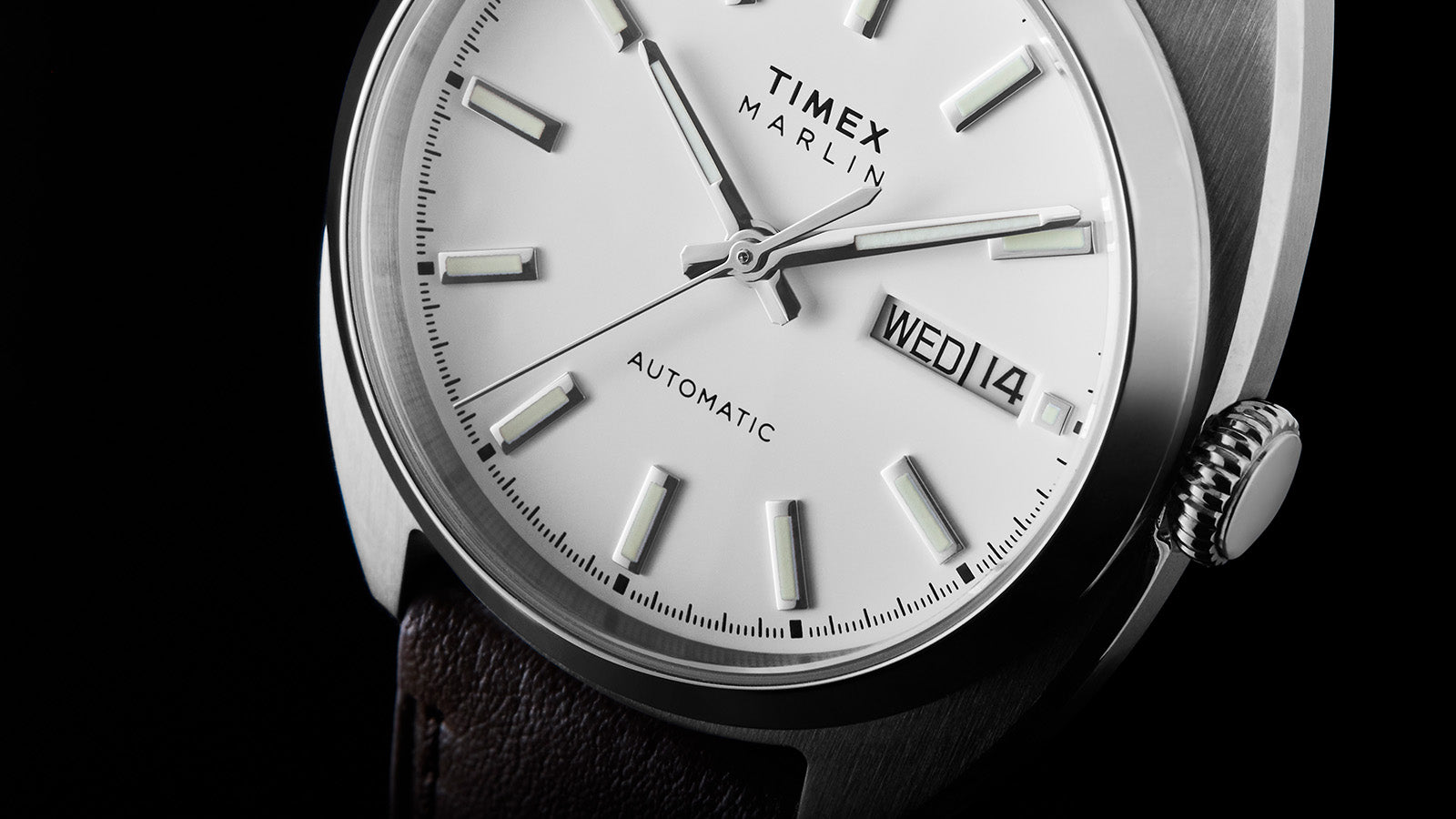 Detail view of the Timex Marlin® Draper Automatic white dial highlighting luminous markers, silver-tone hands, and automatic text.