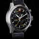 Close-up of Timex Waterbury Ace Fly-Back Chronograph black dial showing subdials, tachymeter scale, and luminous hands
