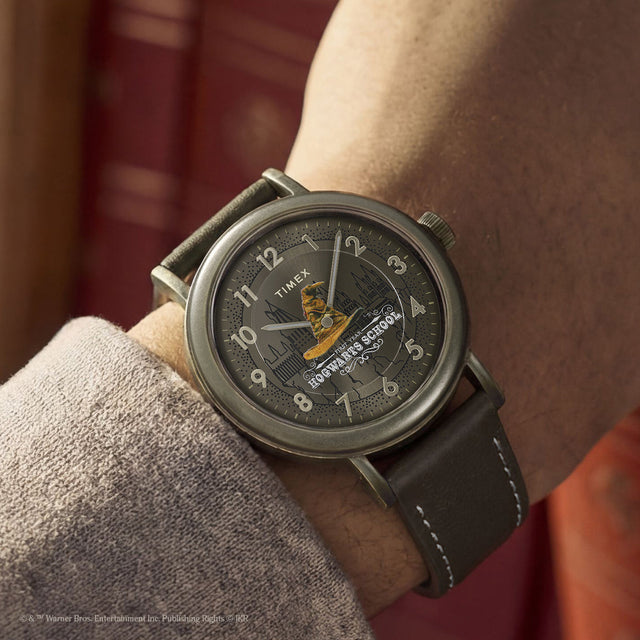 Harry Potter x Timex Weekender Sorting Hat watch worn on wrist featuring Hogwarts castle artwork and Sorting Hat graphic.