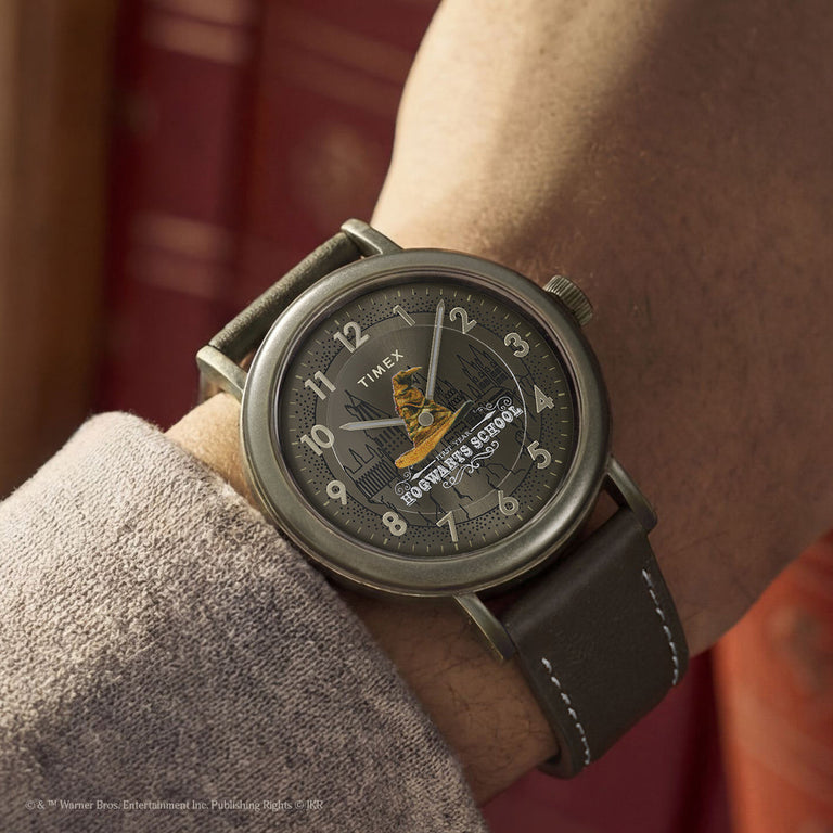 Harry Potter x Timex Weekender Sorting Hat watch worn on wrist featuring Hogwarts castle artwork and Sorting Hat graphic.