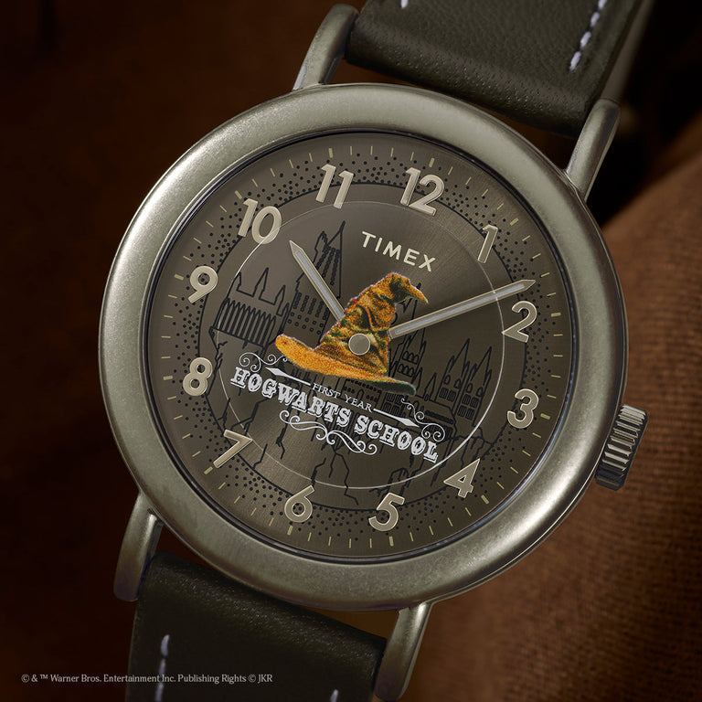 Close-up of Harry Potter x Timex Weekender Sorting Hat dial with Hogwarts School text and detailed Sorting Hat illustration.