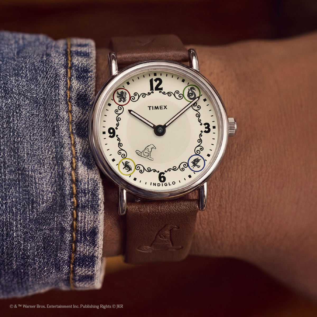 Harry Potter x Timex Weekender Slytherin House watch worn on wrist featuring house icons and Sorting Hat detail.