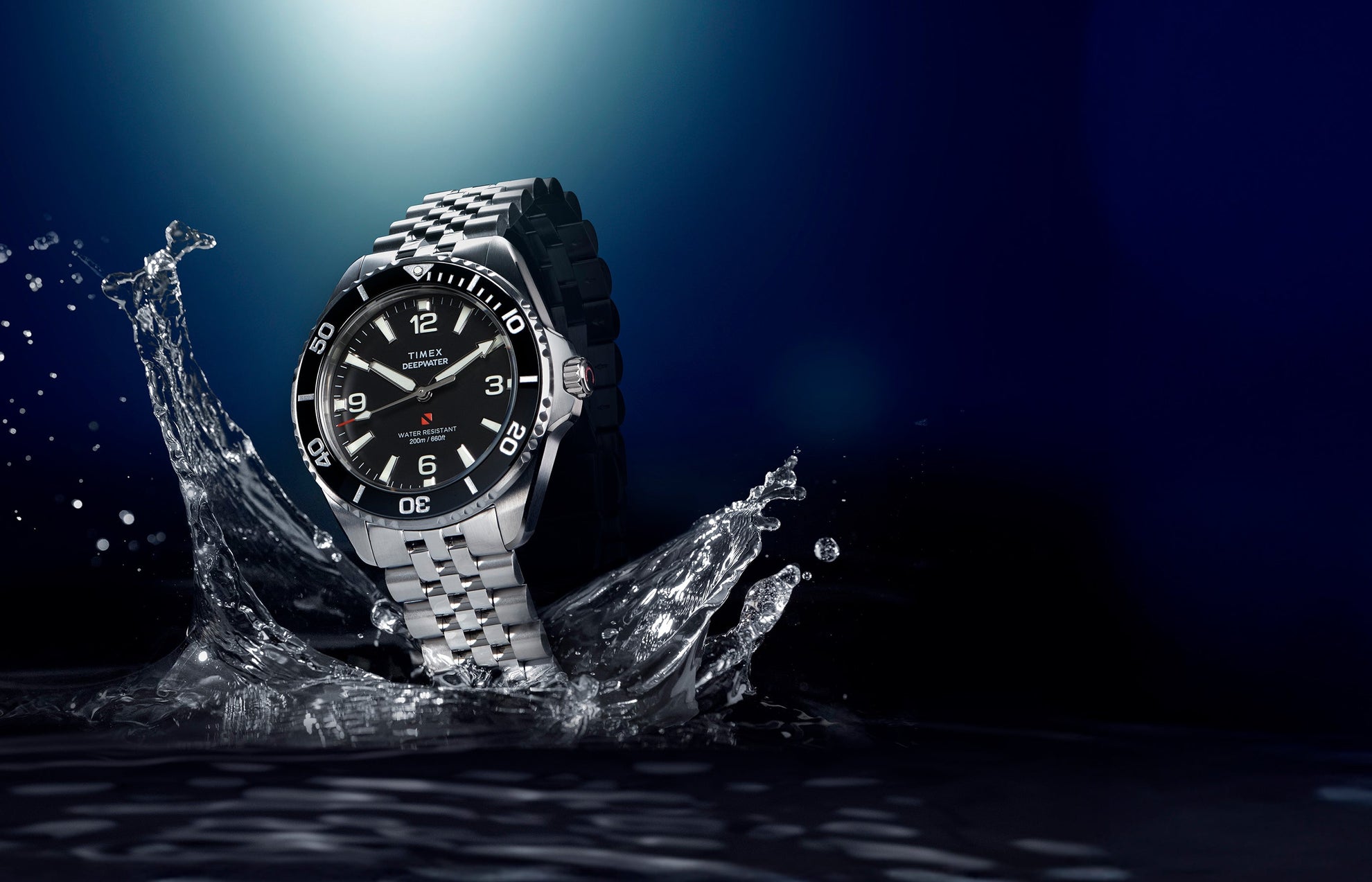 Timex Deepwater Arctic stainless steel dive watch emerging from water with black dial and rotating bezel