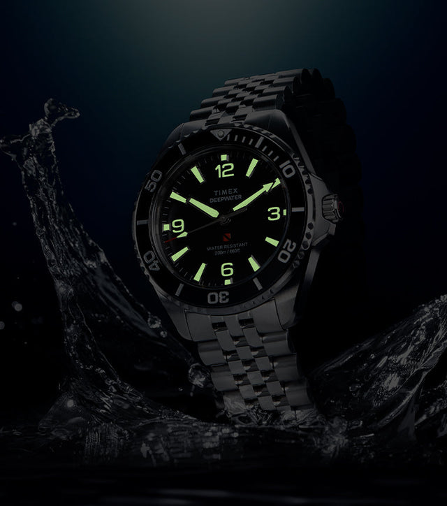 Timex Deepwater Arctic dive watch with glowing lume markers and hands in low light