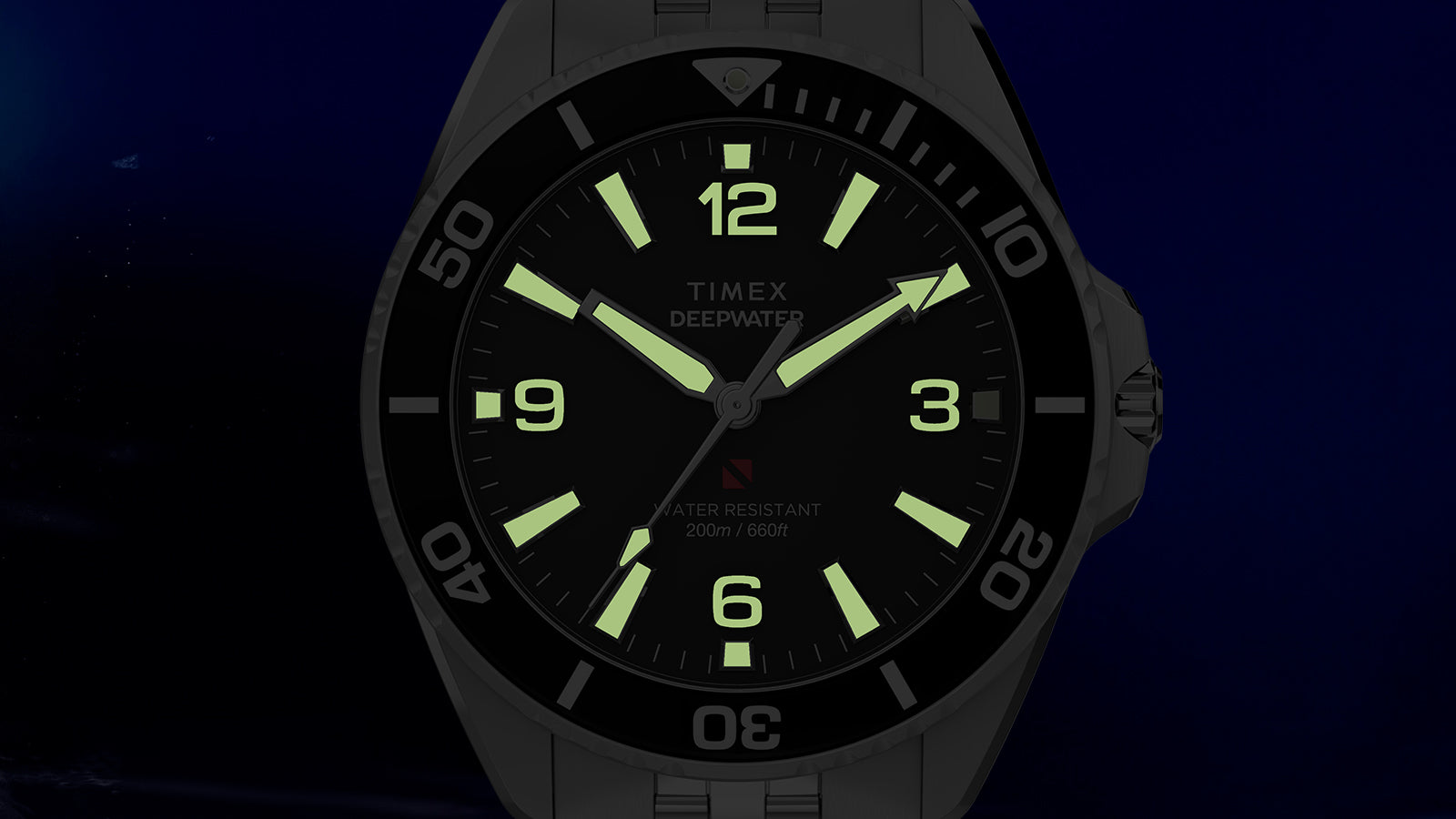Timex Deepwater Arctic watch dial fully illuminated with green lume markers in darkness