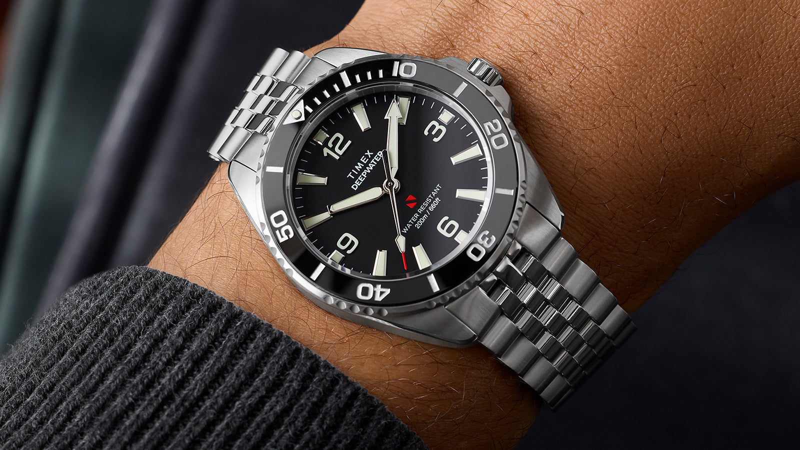 Timex Deepwater Arctic dive watch on wrist showing stainless steel bracelet and black dial