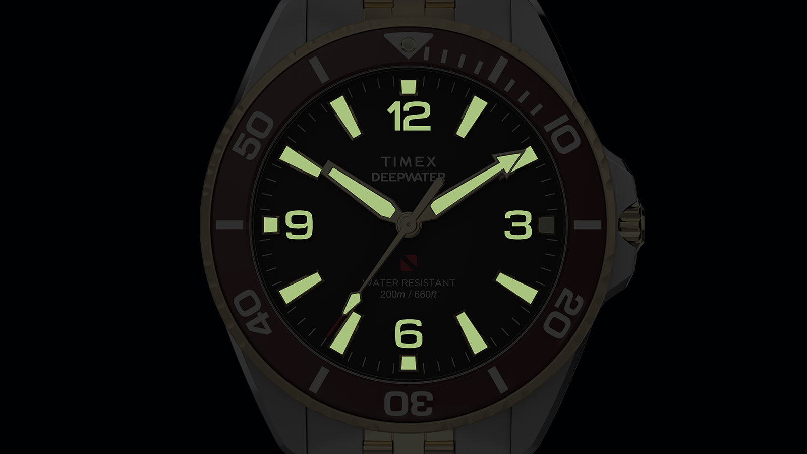 Timex Deepwater Arctic two-tone watch dial fully illuminated with green lume markers in darkness