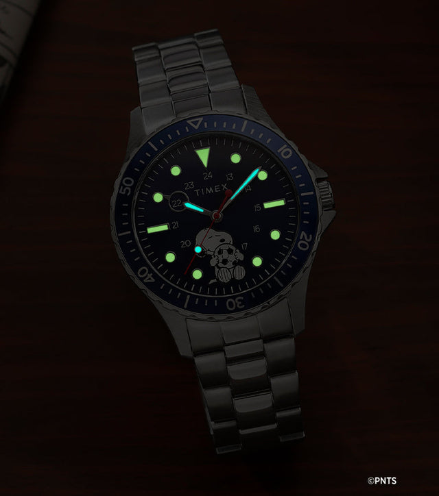 Timex Navi Snoopy soccer watch glowing in the dark with luminous markers and hands on blue dial