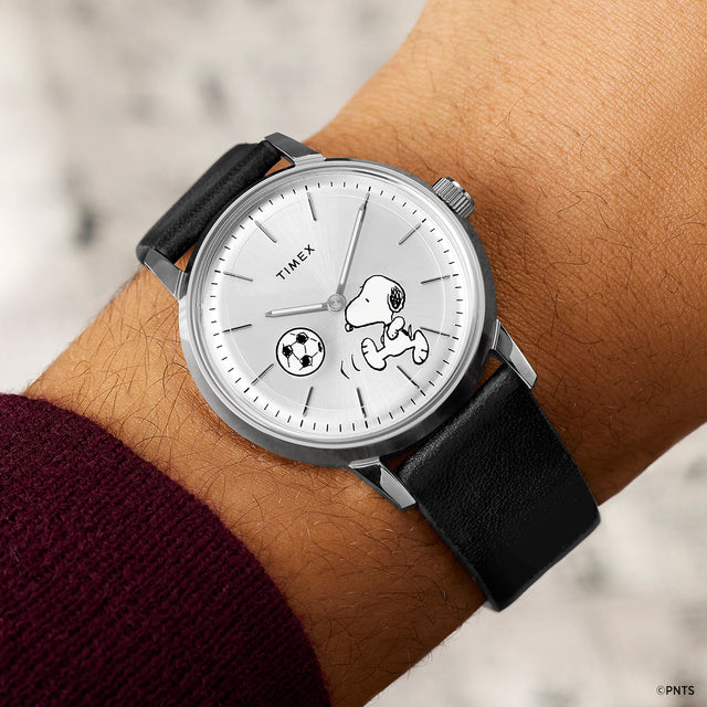 Timex Marlin Automatic x Peanuts Snoopy soccer watch worn on wrist with black leather strap
