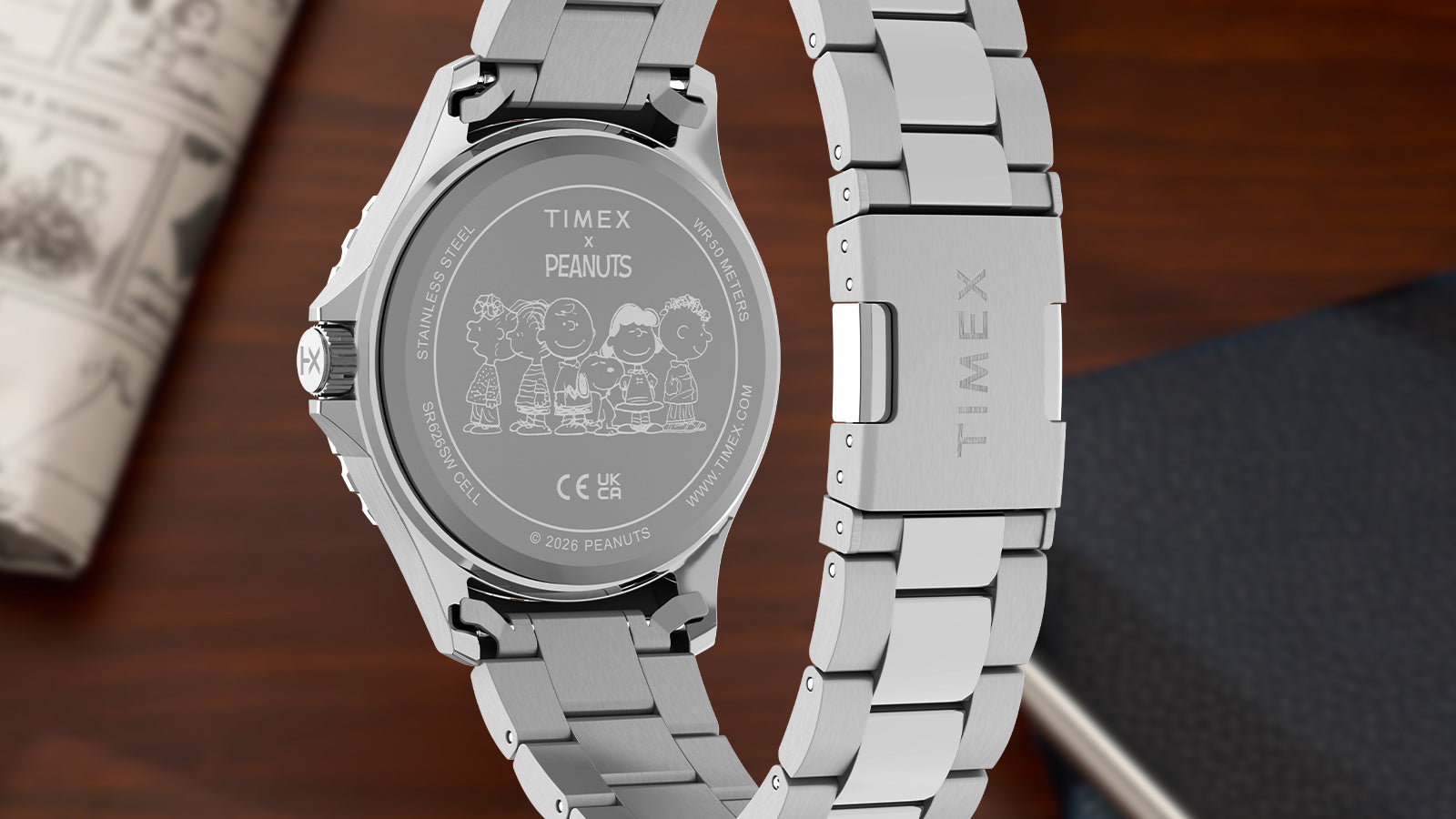 Rear view of Timex Navi x Peanuts watch showing engraved caseback and stainless steel bracelet with Timex clasp
