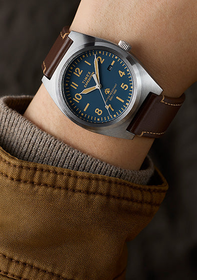 Timex Expedition Capstone watch on wrist with blue dial and brown leather strap