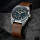 Timex Expedition Capstone watch with blue dial and brown leather strap on rock surface