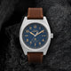 Close-up of Timex Expedition Capstone watch with blue dial, Arabic numerals, and leather strap