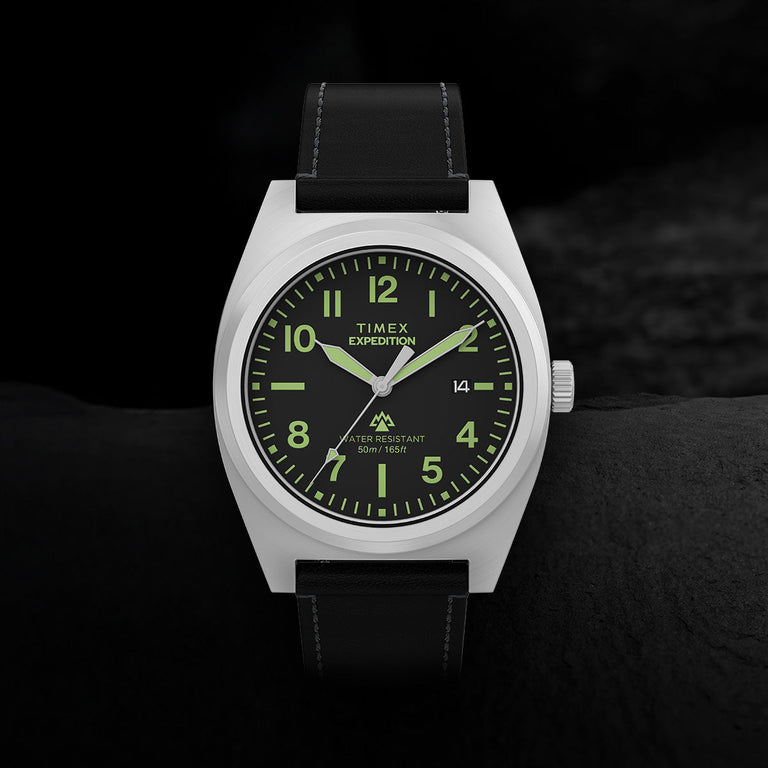 Close-up of Timex Expedition Capstone watch with black dial, Arabic numerals, and leather strap