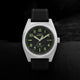 Close-up of Timex Expedition Capstone watch with black dial, Arabic numerals, and leather strap