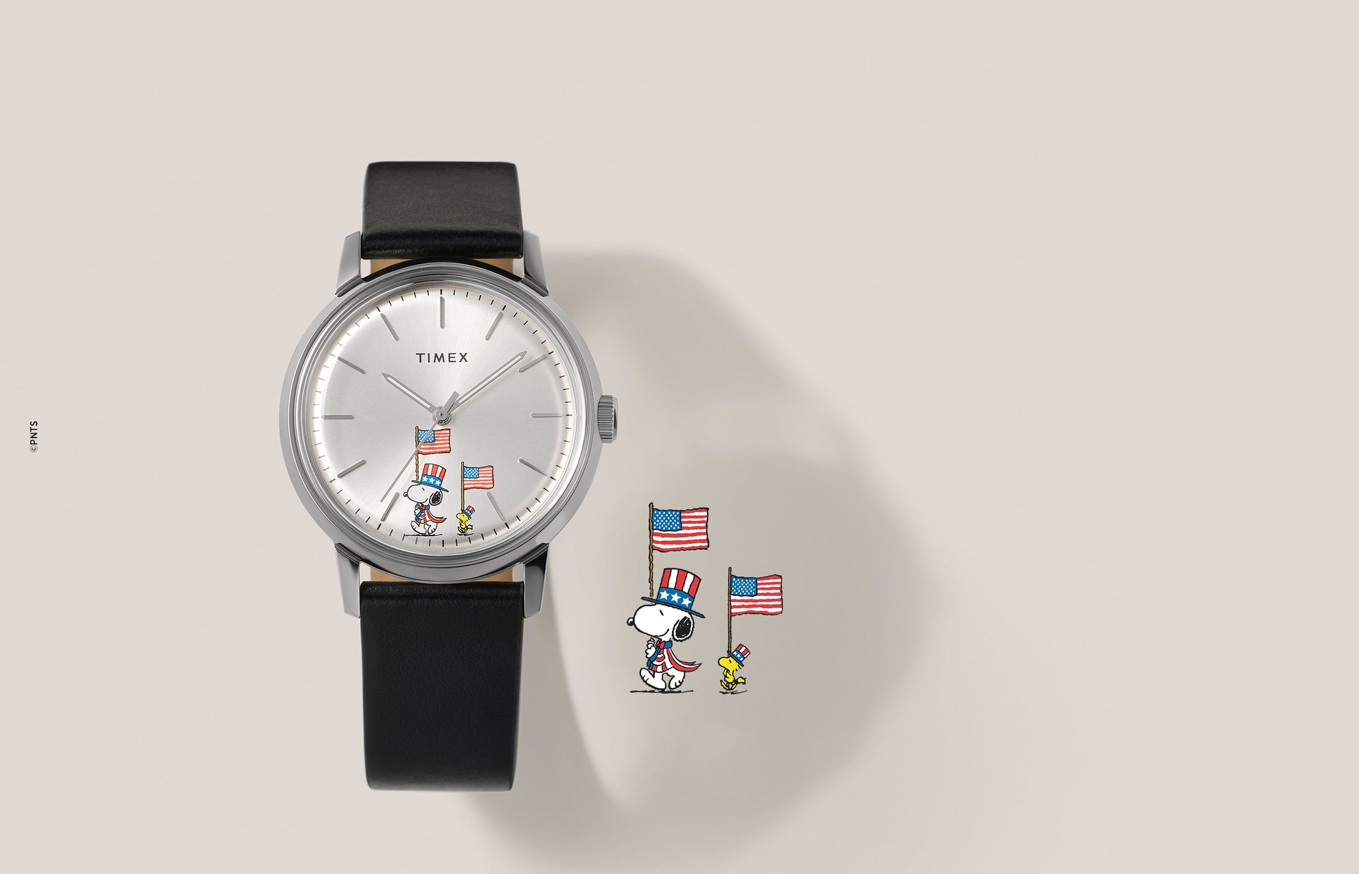 Timex Marlin Automatic x Peanuts Americana watch with silver dial, black leather strap, and Snoopy and Woodstock holding American flags