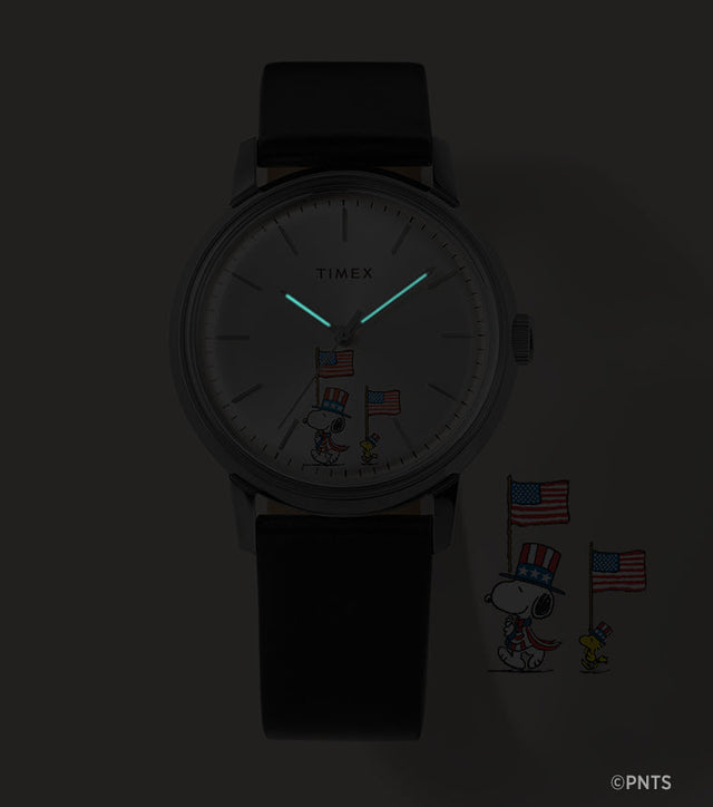 Timex Marlin Automatic Peanuts Americana watch showing glowing hands in low light with Snoopy dial detail
