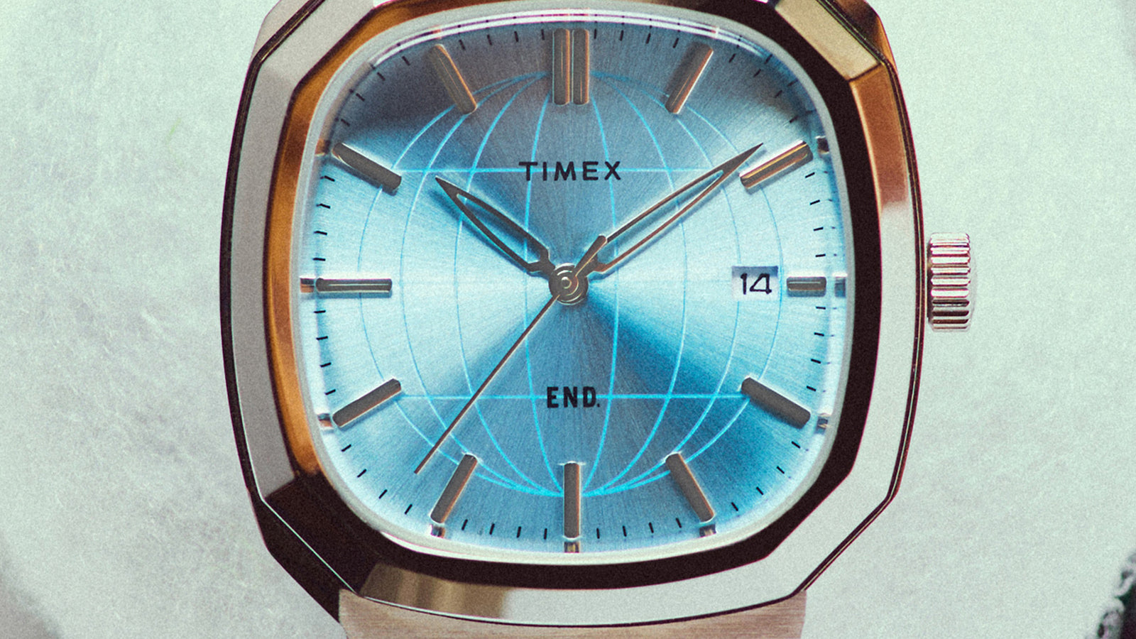 Close-up of the END. x Timex 1981 Reissue Inspired watch dial with globe-inspired artwork and date window.