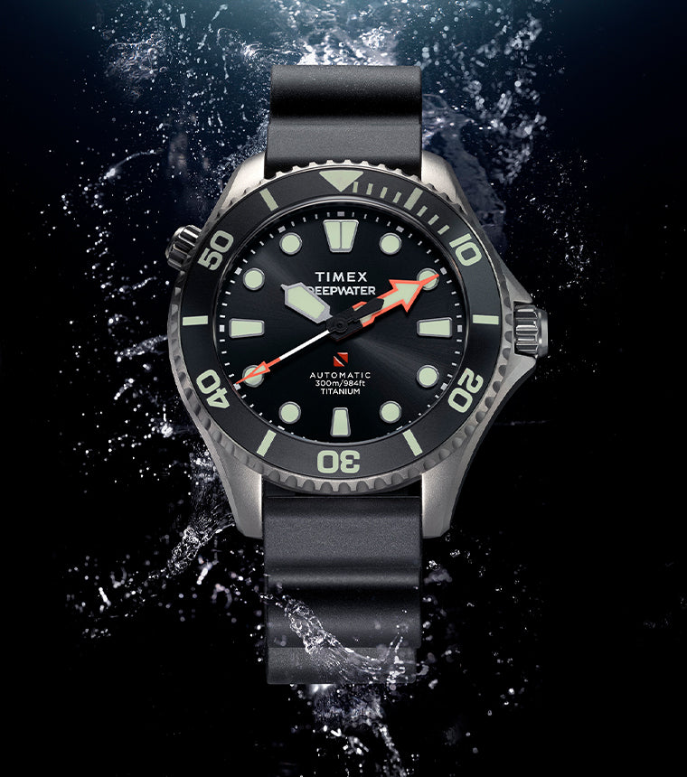 Timex Deepwater Meridian 300 Titanium HEV Automatic dive watch with black dial and luminous markers emerging from a dramatic underwater splash backdrop.