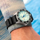 Timex Deepwater Meridian 300 Titanium HEV Automatic with full-lume dial worn on the wrist near open water.