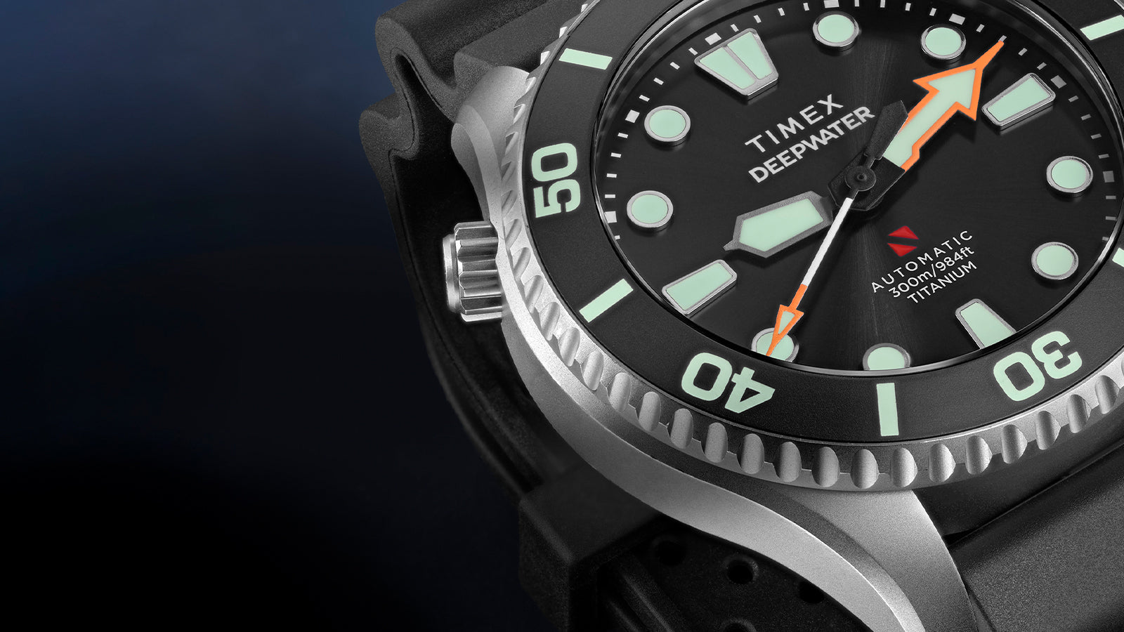 Macro detail of the Timex Deepwater Meridian 300 Titanium HEV Automatic highlighting the titanium case, bezel, and luminous dial markers.