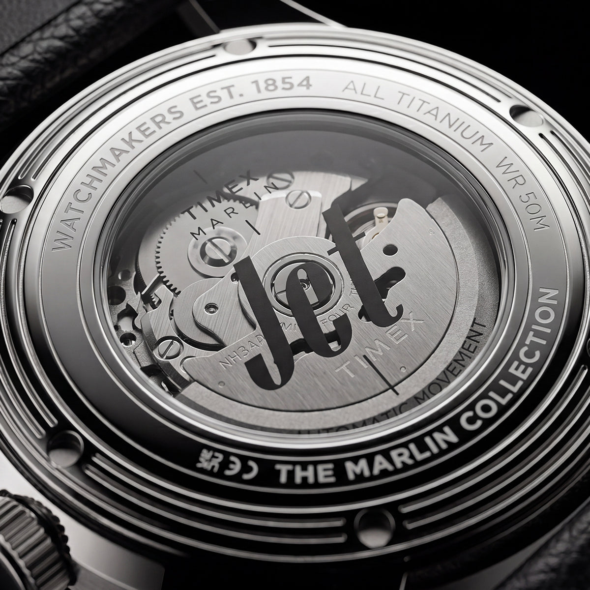 Exhibition caseback of the Timex Marlin® Jet Titanium Automatic GMT showing the automatic movement and custom Timex rotor through a transparent crystal caseback.