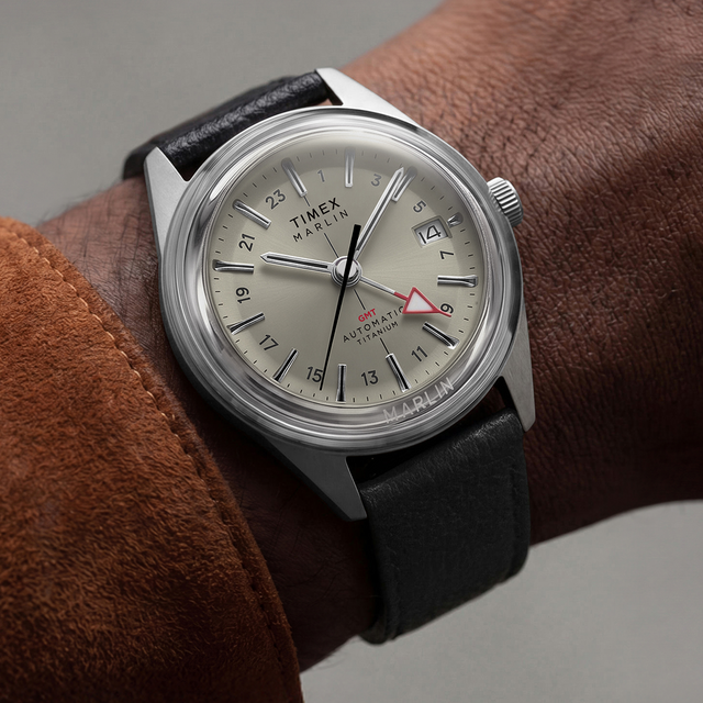 Close-up of the Marlin® Jet Titanium Automatic GMT on the wrist, featuring a cream dial, red GMT hand, date window, and black leather strap.