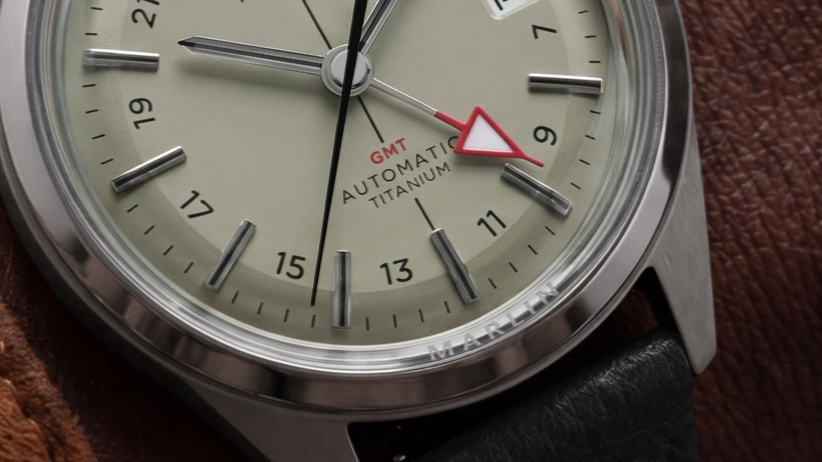 Close-up of the Timex Marlin® Jet Titanium Automatic GMT dial highlighting the red GMT hand, applied hour markers, and titanium automatic movement designation.
