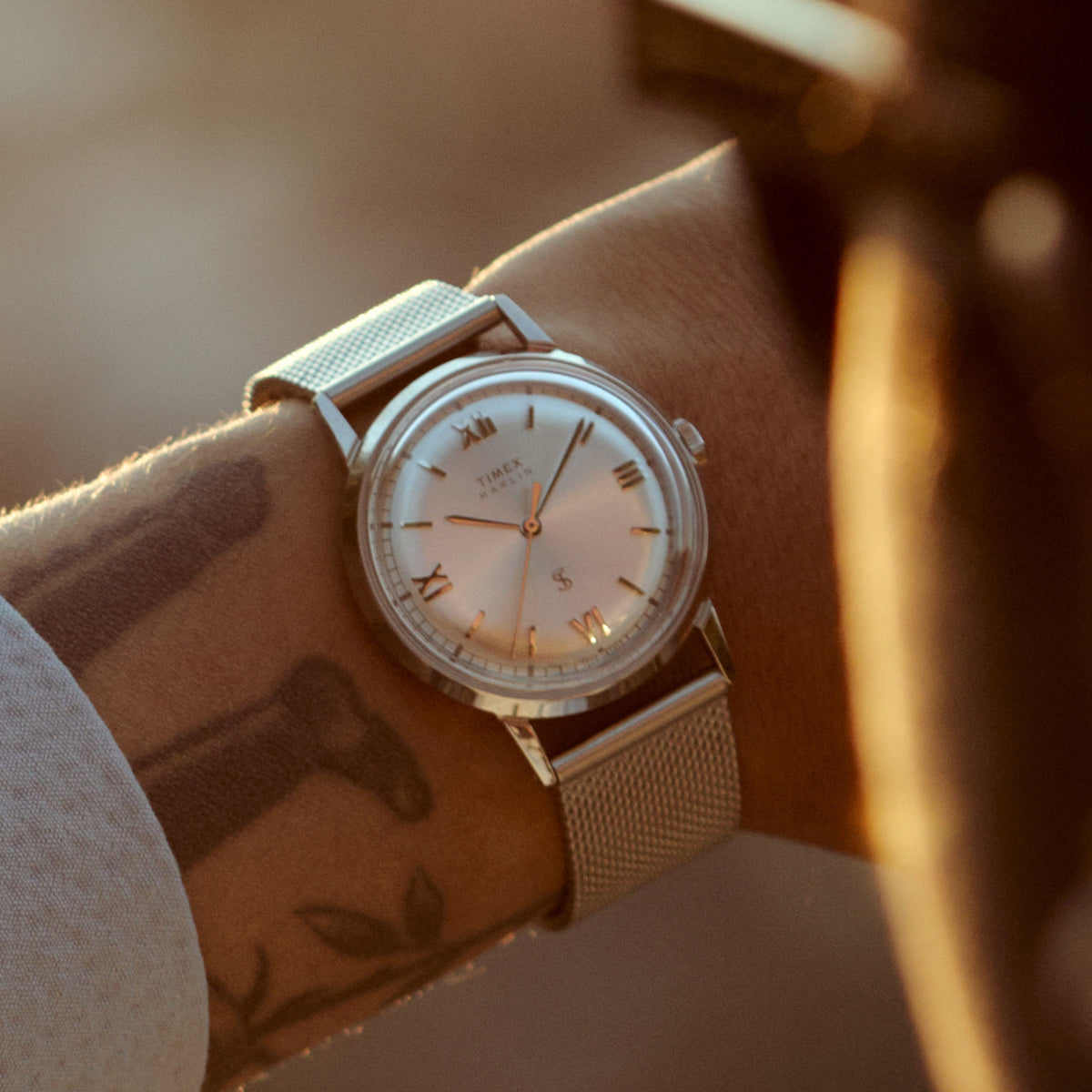 Close-up of the Todd Snyder x Timex Marlin® Mesh watch with a silver sunray dial and stainless steel mesh bracelet worn on the wrist.