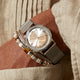 Todd Snyder x Timex Marlin® Mesh watch with a silver sunray dial and stainless steel mesh bracelet paired with layered beaded bracelets.