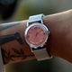 Close-up of the Todd Snyder x Timex Marlin® Mesh watch with a pink dial and stainless steel mesh bracelet worn on the wrist.