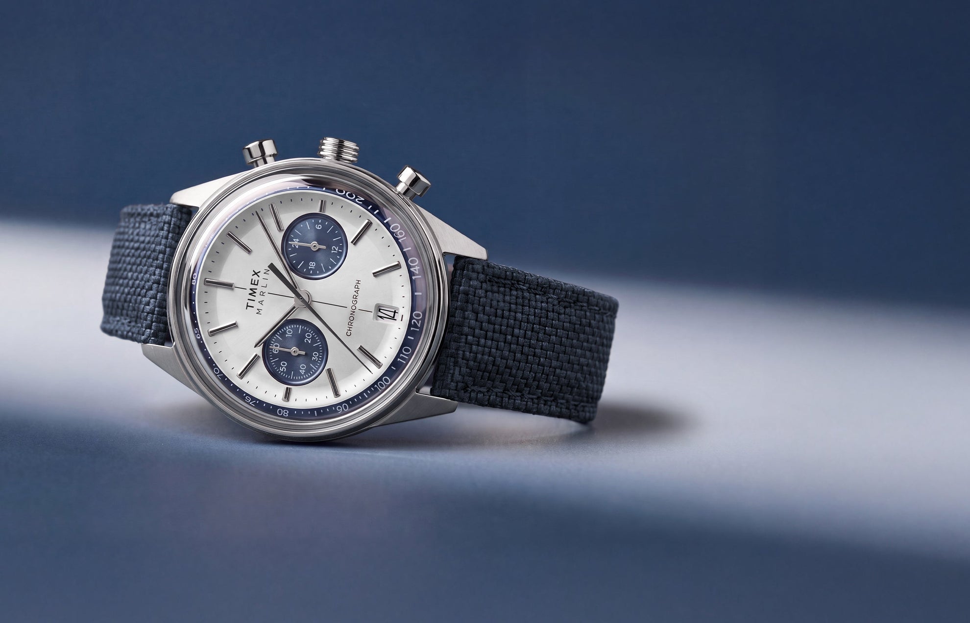 Timex Marlin® Jet Chronograph with a silver-tone dial, blue subdials, and blue fabric strap.