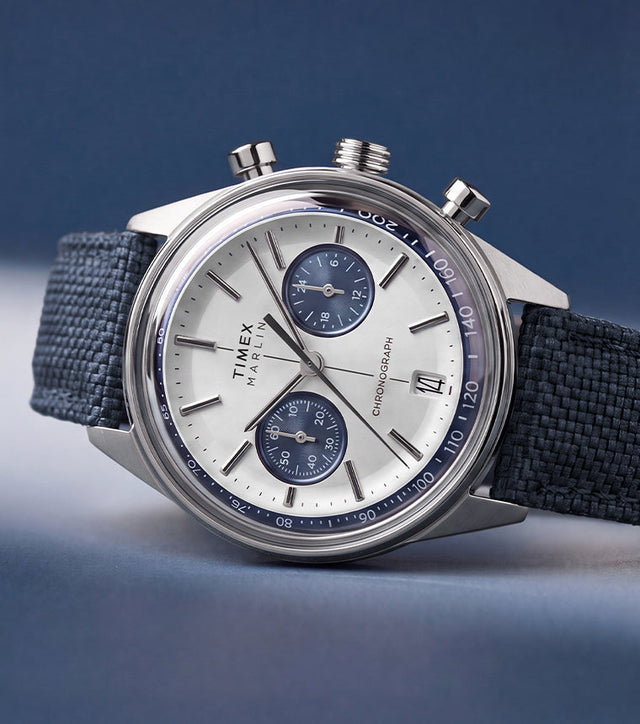 Timex Marlin® Jet Chronograph with a silver-tone dial, blue subdials, and blue fabric strap.