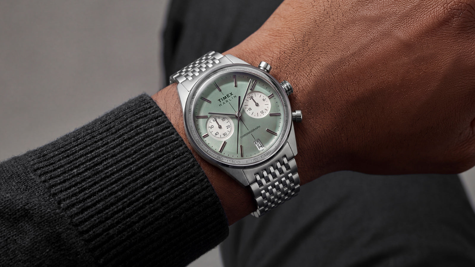 Timex Marlin® Jet Chronograph with a green dial and stainless-steel bracelet worn on the wrist.