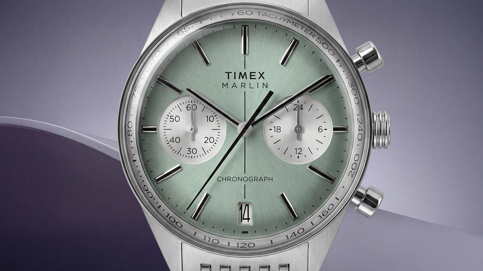 Close-up of the green dial on the Timex Marlin® Jet Chronograph, featuring white subdials, a date window, and tachymeter scale.