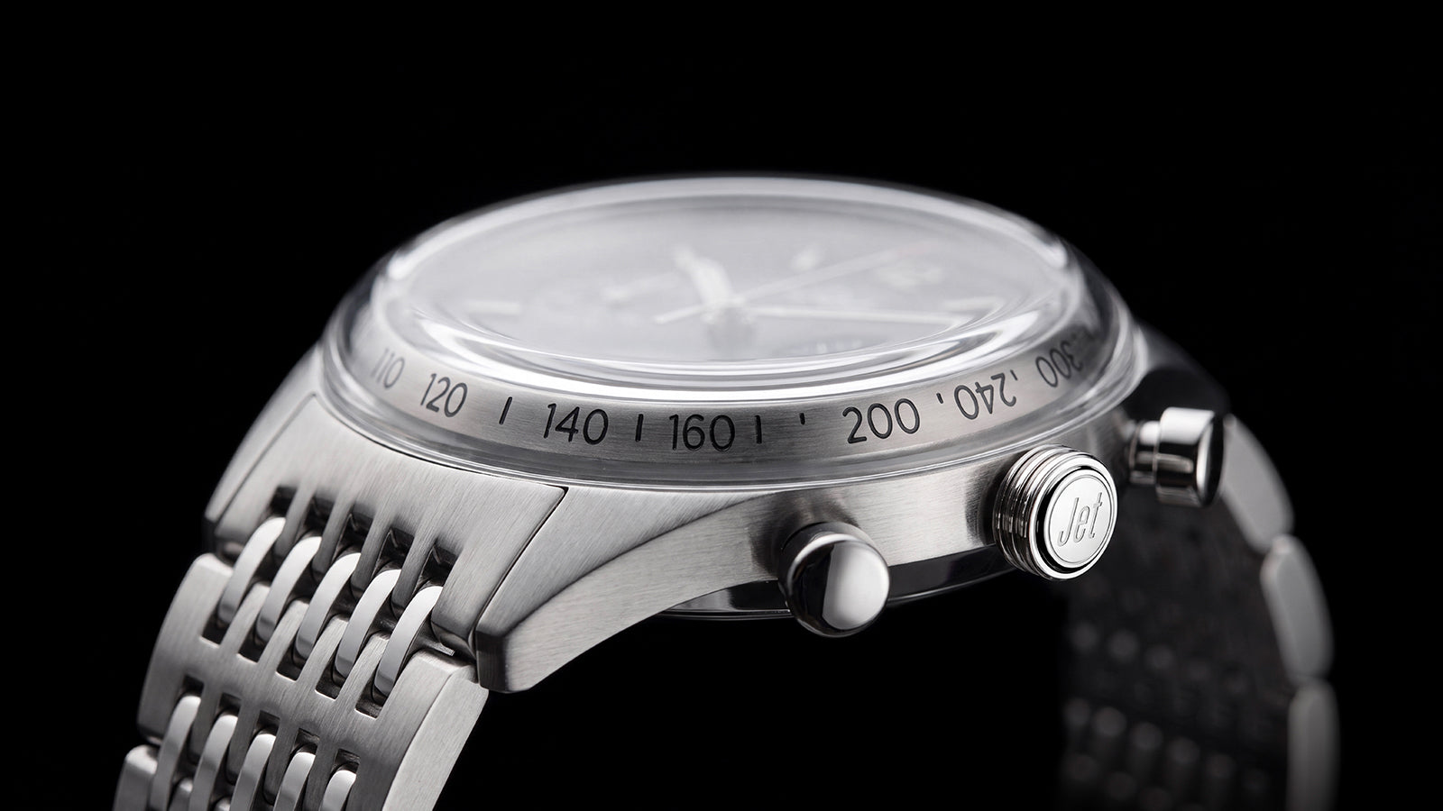 Side view of the Timex Marlin® Jet Chronograph highlighting its domed crystal, tachymeter scale, crown, pushers, and stainless-steel bracelet.