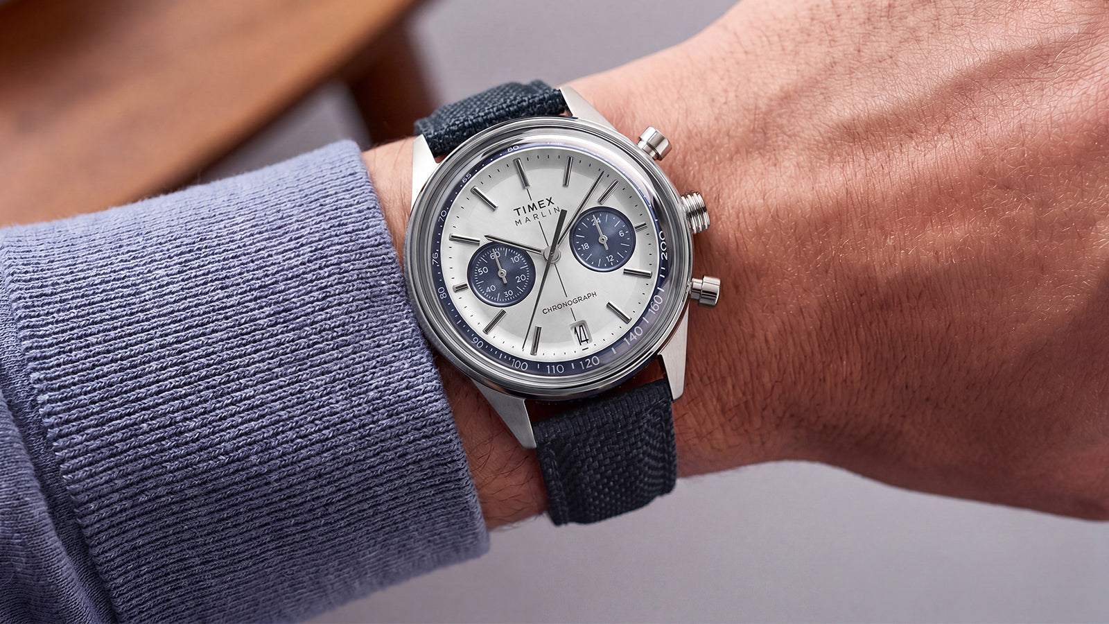 Timex Marlin® Jet Chronograph with a silver-tone dial, blue subdials, and blue fabric strap worn on the wrist.