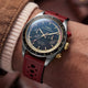 Timex Waterbury Heritage Chronograph with a red perforated leather racing strap and blue chronograph dial worn on the wrist.
