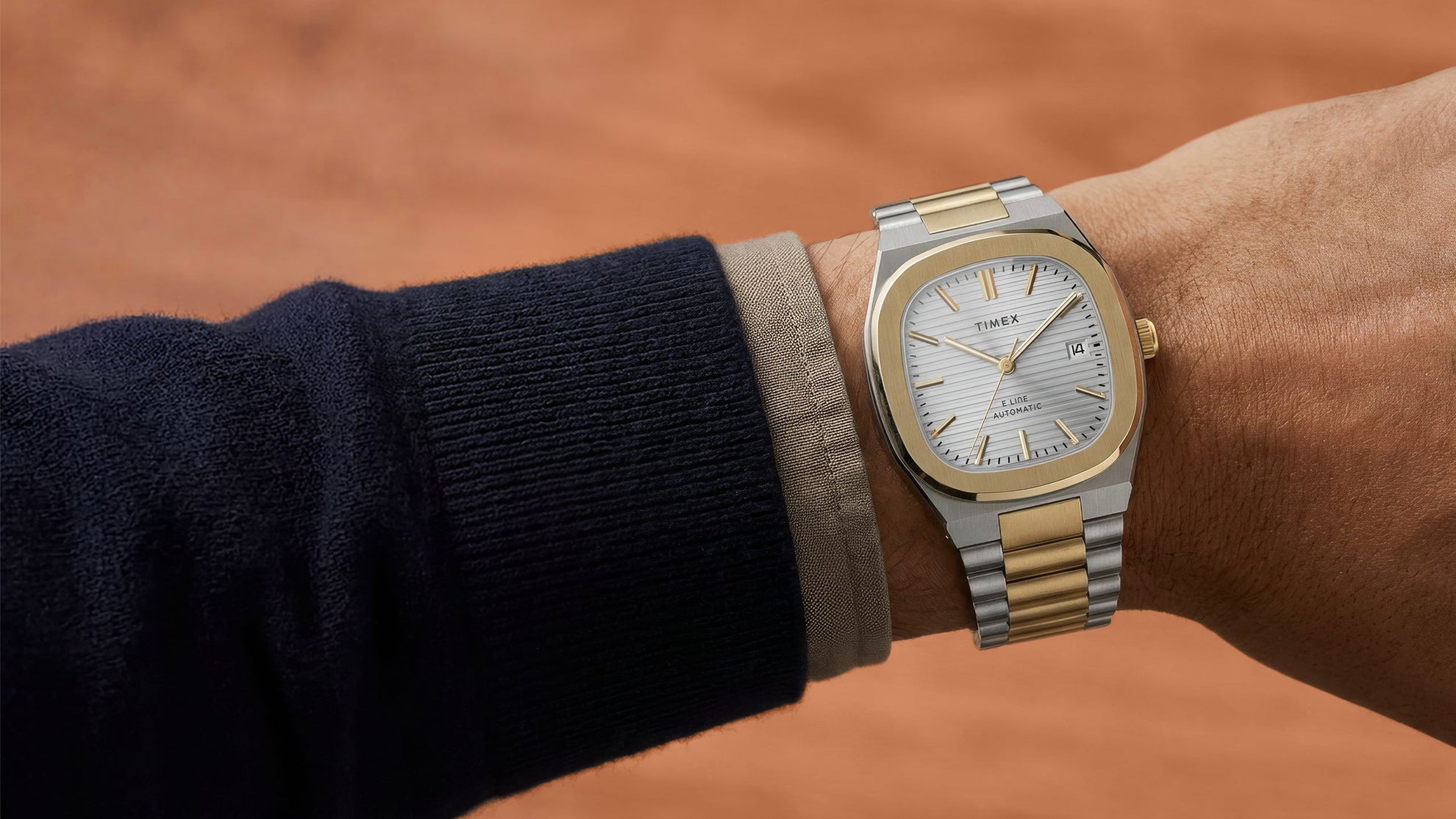 Timex Automatic E Line 38mm with a silver-tone dial and two-tone stainless-steel bracelet, shown on the wrist.
