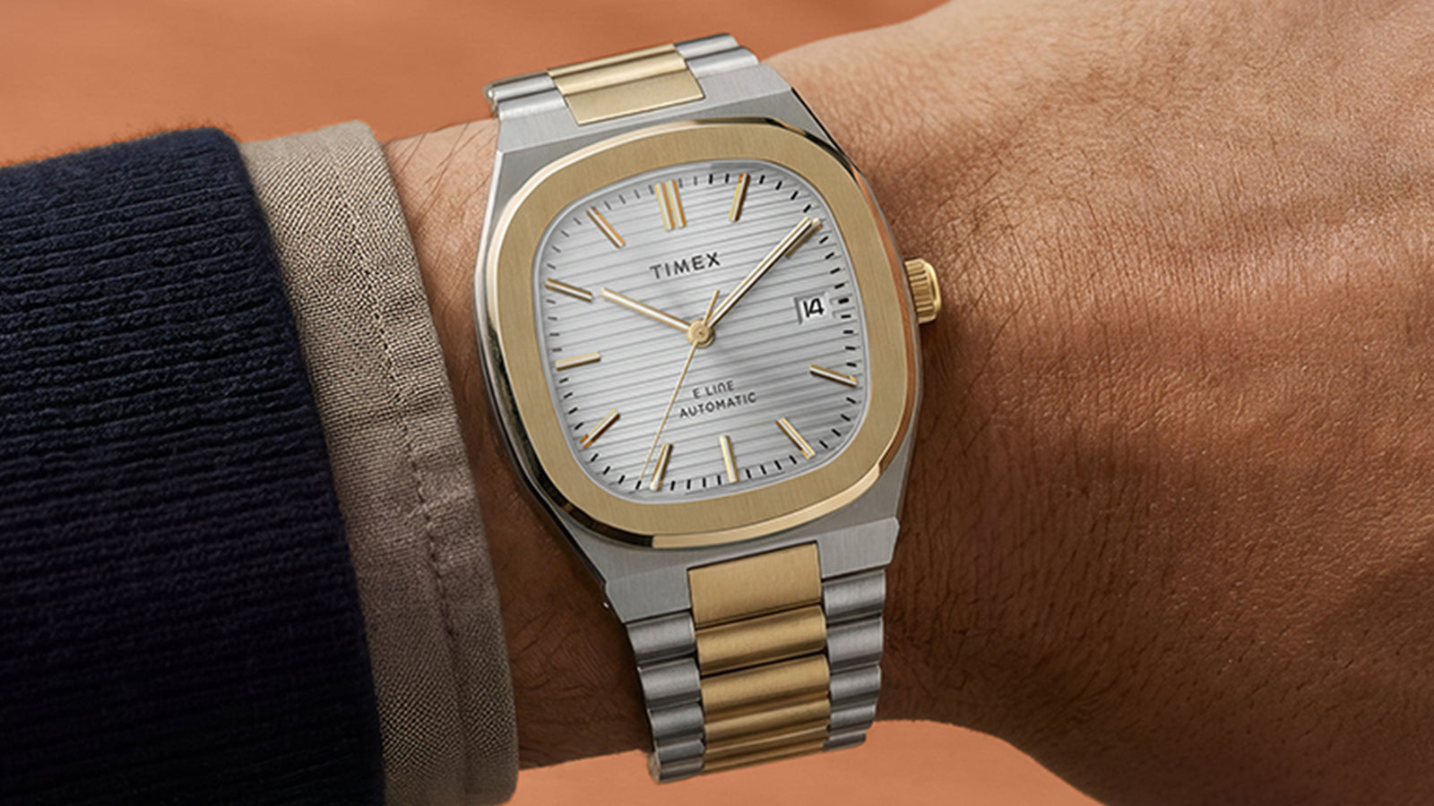 Timex® Automatic E Line 38mm two-tone stainless steel watch with a silver textured dial worn on the wrist.