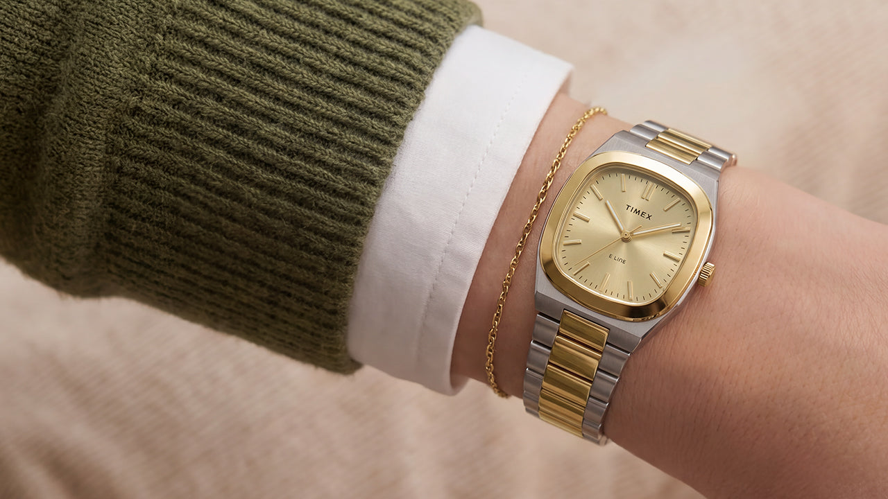 Close-up of the Timex® Quartz E Line 30mm two-tone stainless steel watch with a champagne dial worn on the wrist.