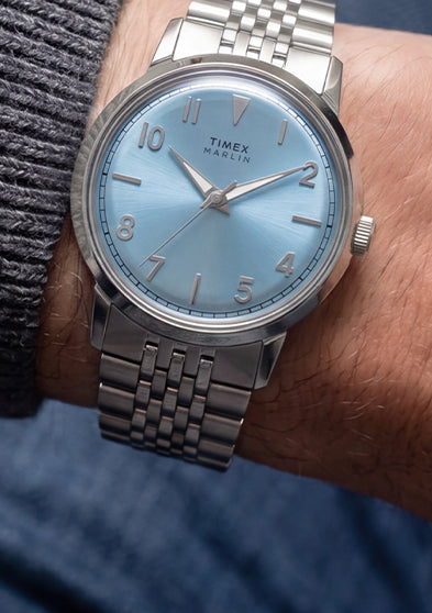 Close-up of the Timex Marlin Quartz with an ice blue dial and stainless steel bracelet worn on the wrist.