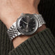 Timex Marlin Quartz with a black sunray dial and stainless steel bracelet worn on the wrist.
