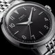 Macro view of the Timex Marlin Quartz black sunray dial with applied silver-tone Arabic numerals, luminous hands, and polished stainless steel case.